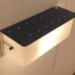 Perforated wall light with blue lacquered metal and perspex by Jacques Biny